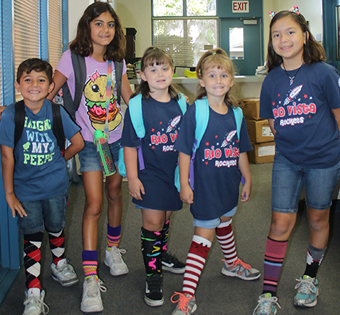 five students wearing crazy socks